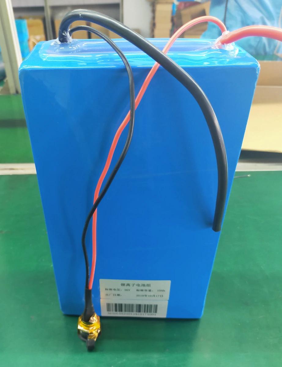 Original photograph of a blue 36V 10Ah battery pack with cable leads