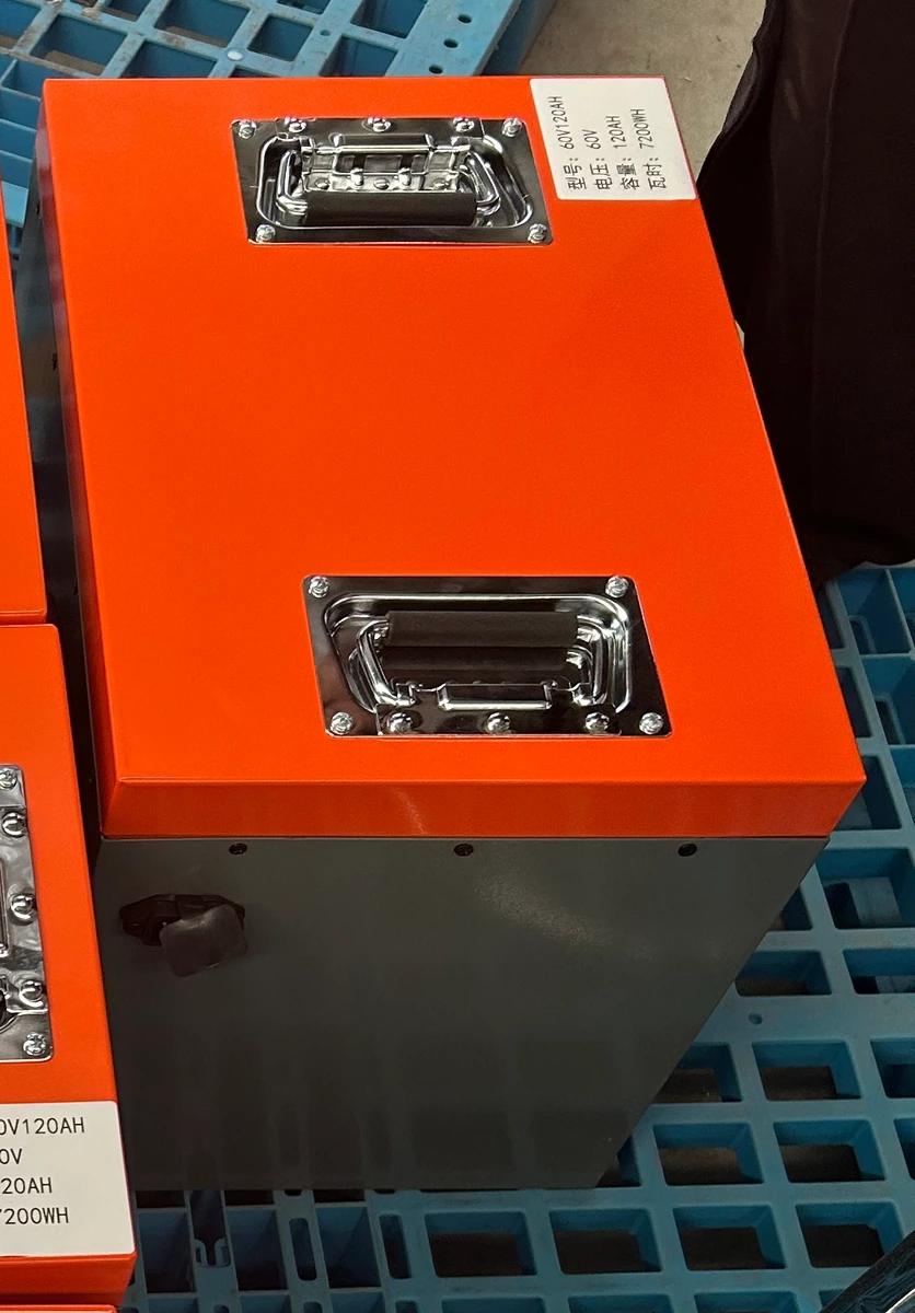 Original photograph of the orange-lid gray metal 60V 120Ah battery pack