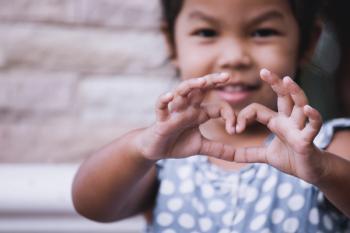 Little girl making heart shape with hands in vintage color tone, charity, giving back | Image Credit: © pingpao - stock.adobe.com