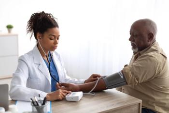 Doctor checking measuring pressure on patient's hand pulse