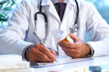 Doctor writing prescription | Image credit: 18percentgrey – stock.adobe.com