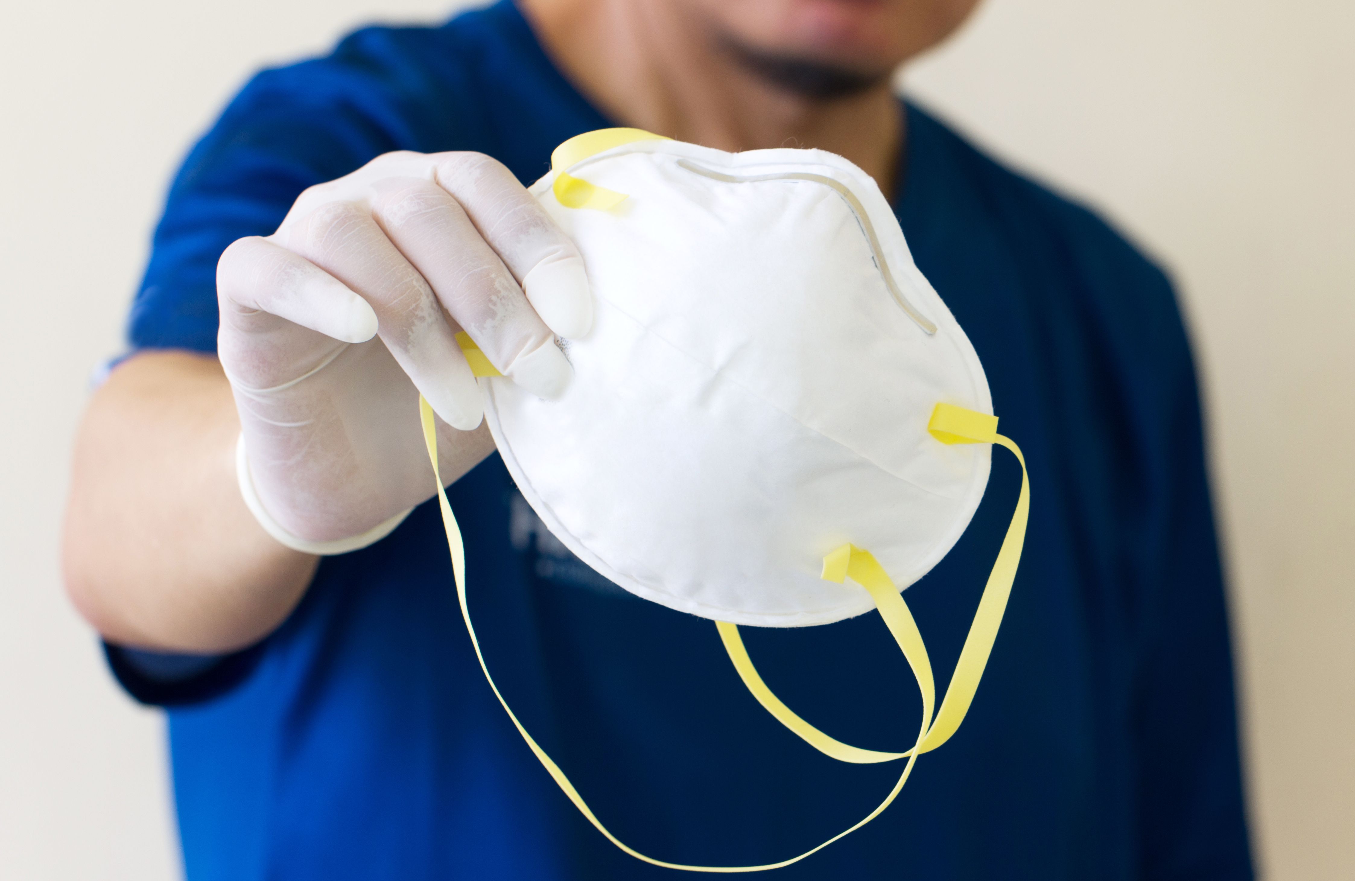 Picture of man holding face mask