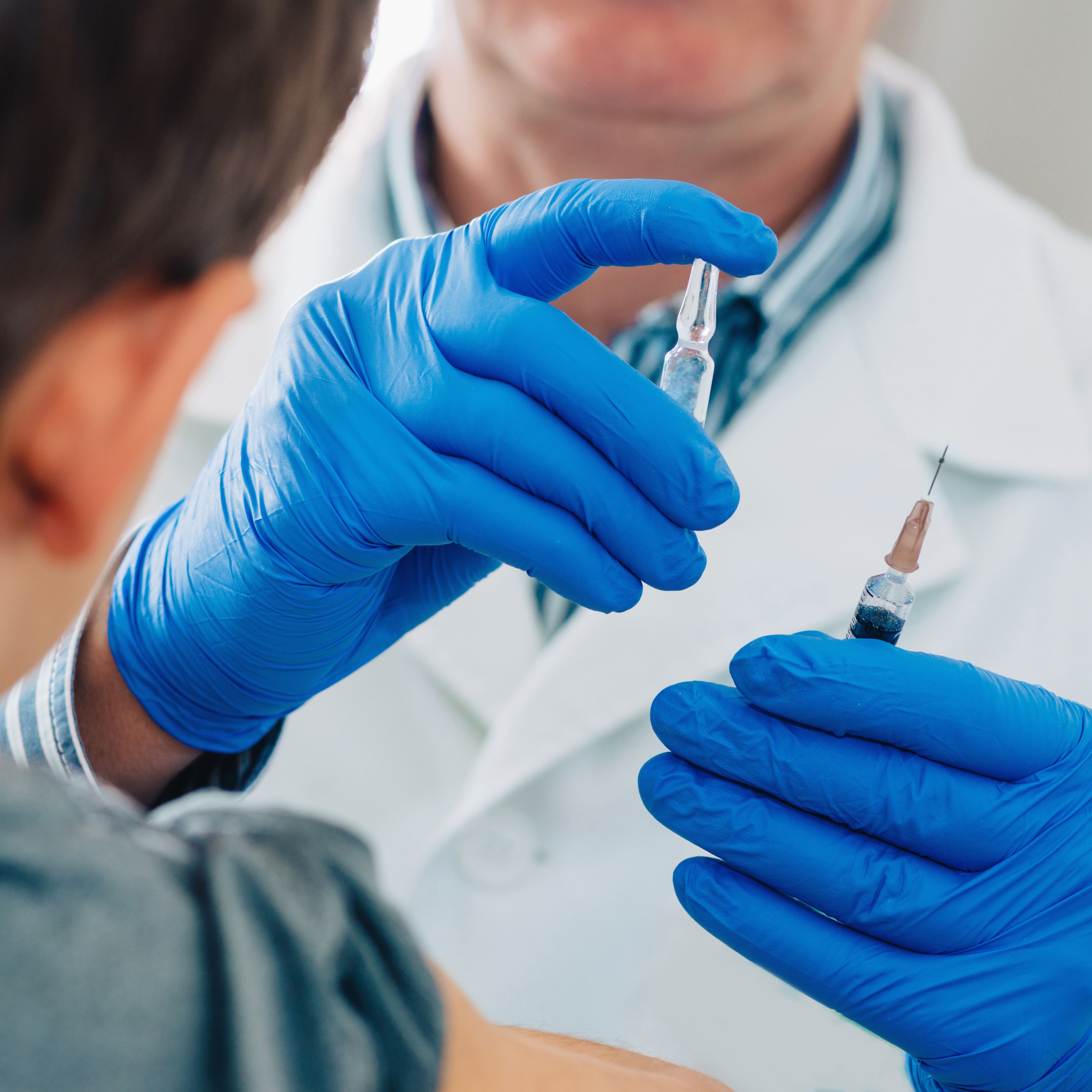 doctor holding needle