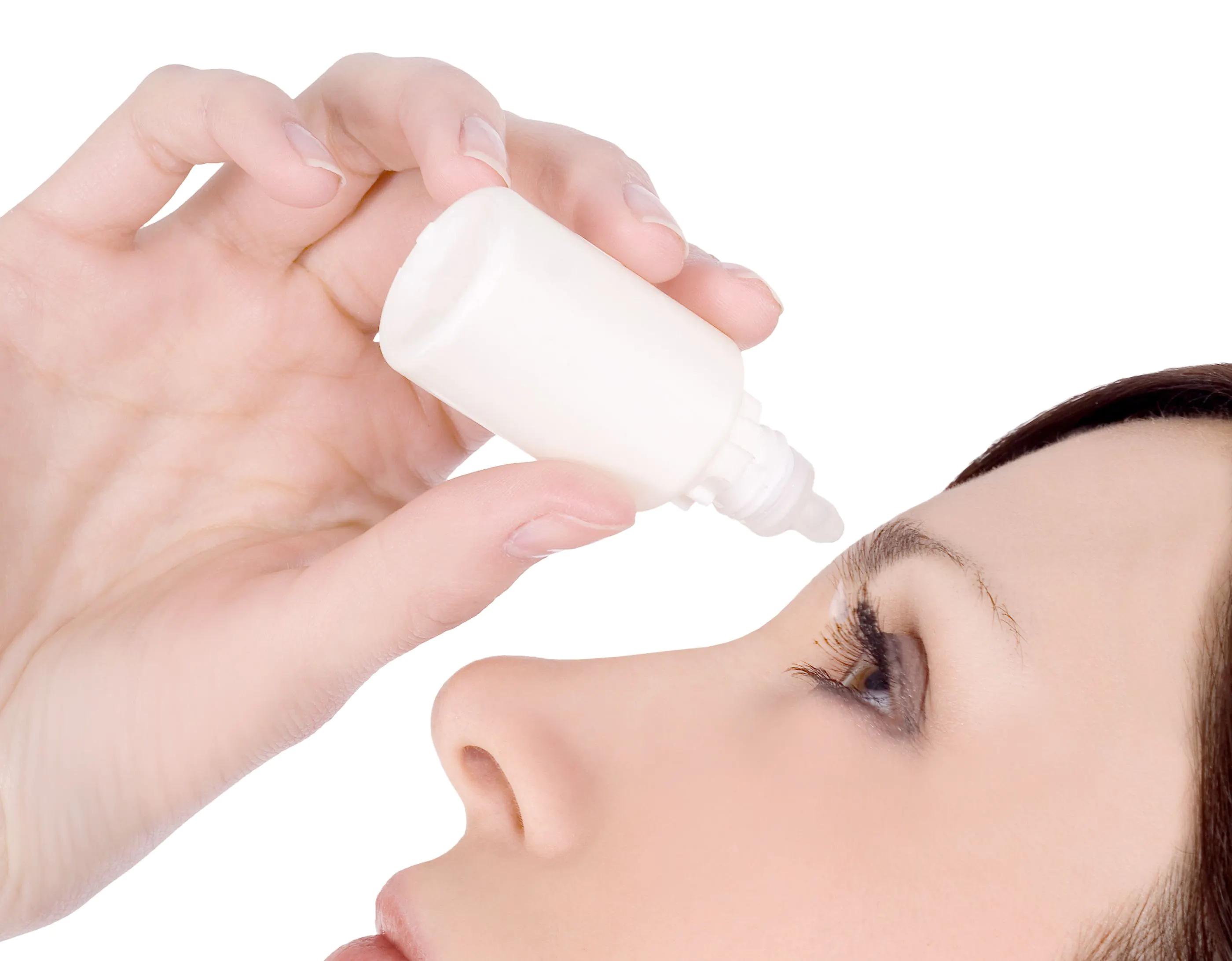 Woman using eyedrops