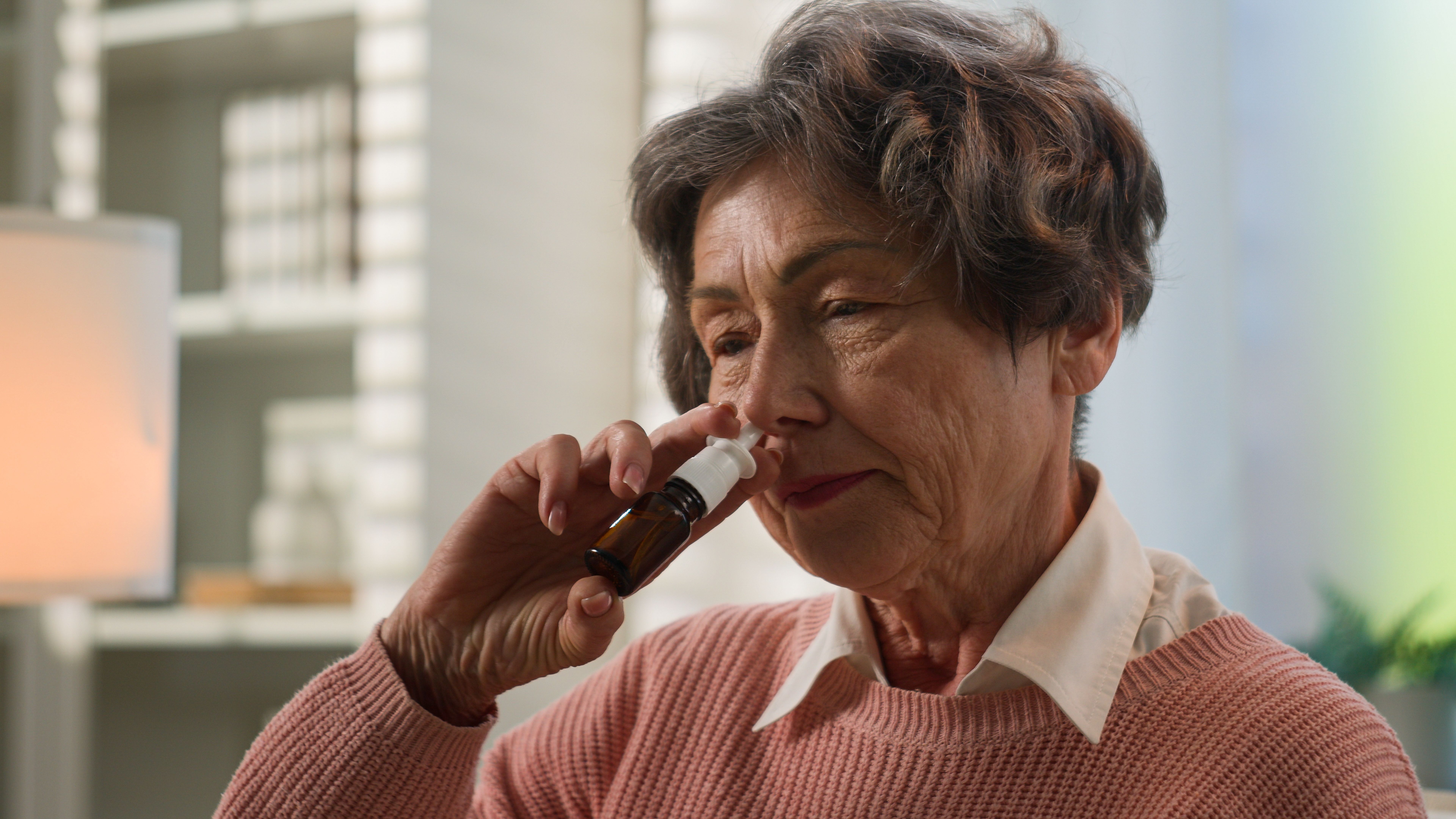 Older woman using nose spray | Image credit: Yuliia – stock.adobe.com