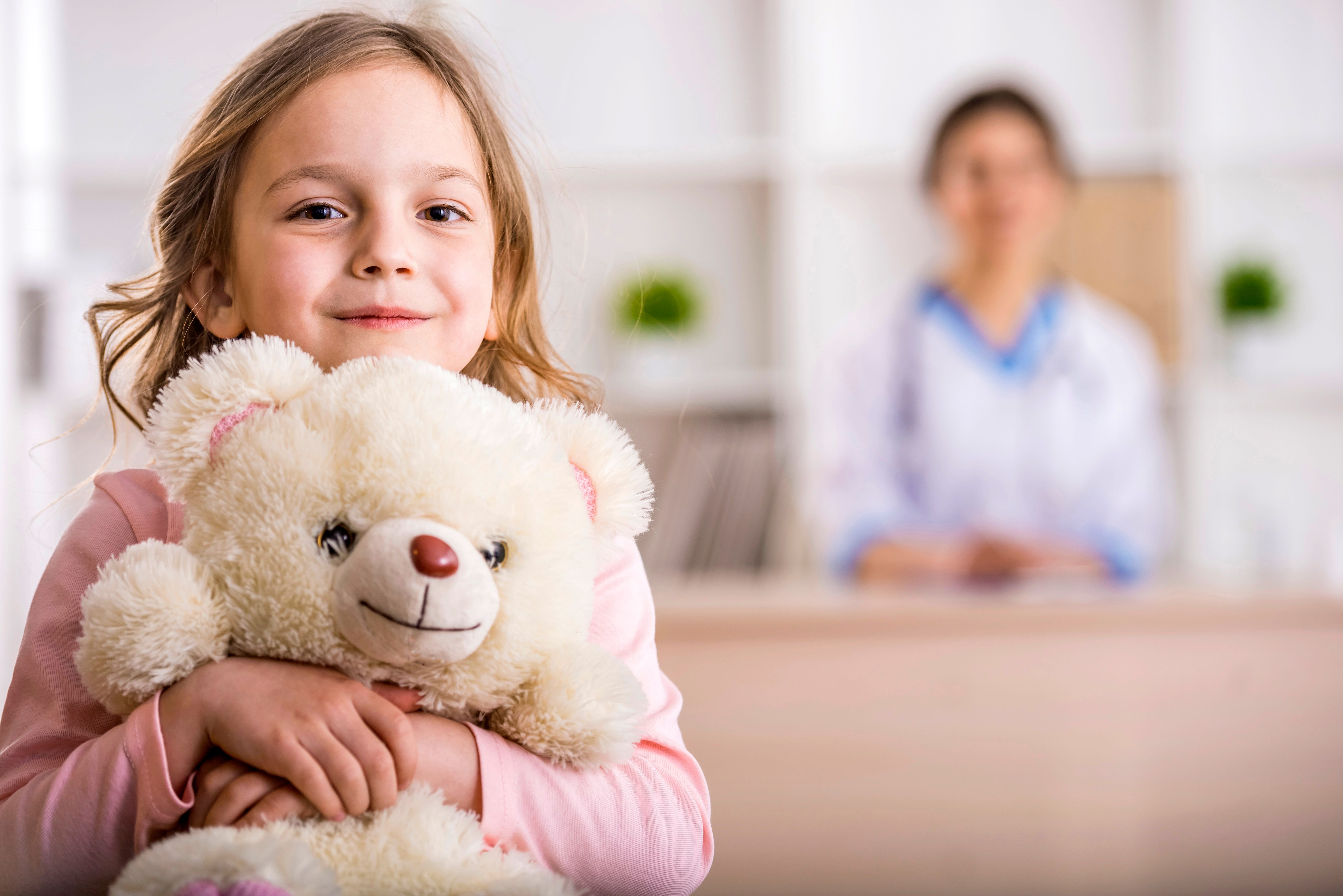 Child at pediatrician's office holding teddy bear | Image credit: VadimGuzhva – stock.adobe.com