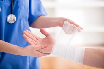 doctor putting dressing over someone's wrist