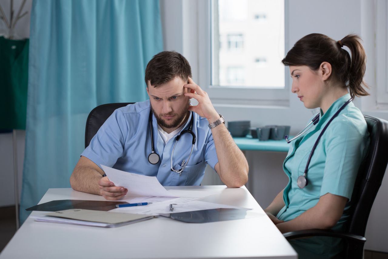 Health care workers reading on task.