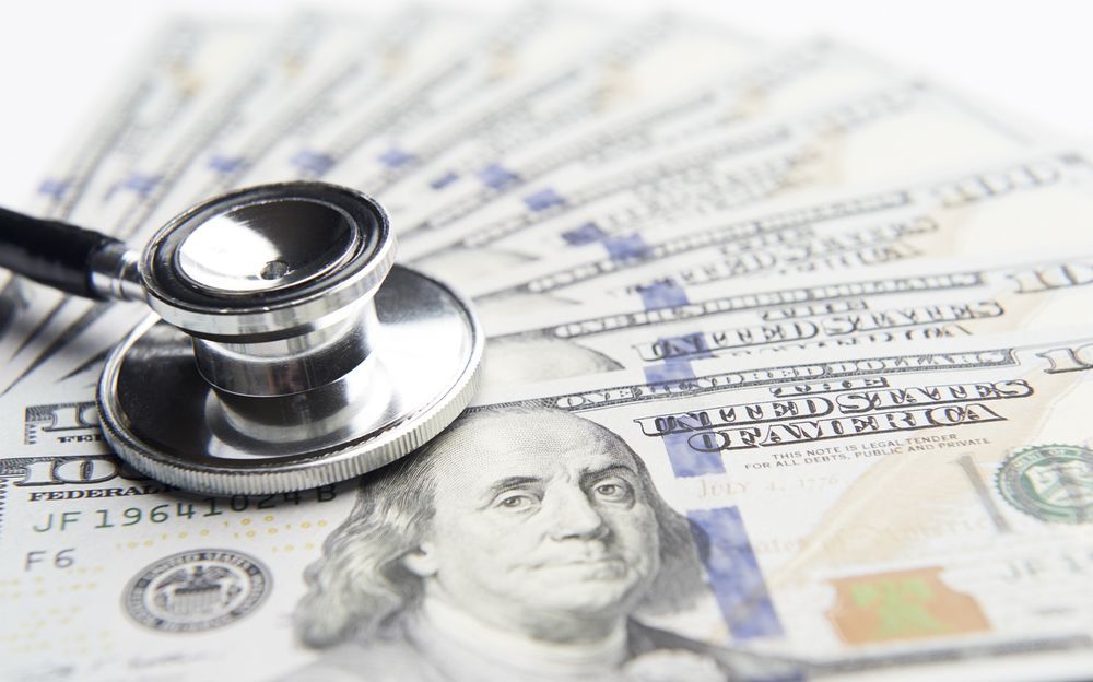 Image of a stethoscope on hundred dollar bills