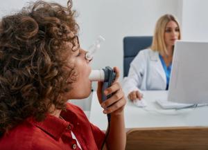 Pulmonary function test using medical spirometer. | Image credit: @Peakstock_AdobeStock.jpeg