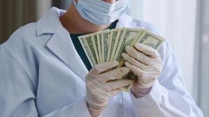 doctor accepting money for prescribing MS medicines | Image credit: Yuliia - stock.adobe.com