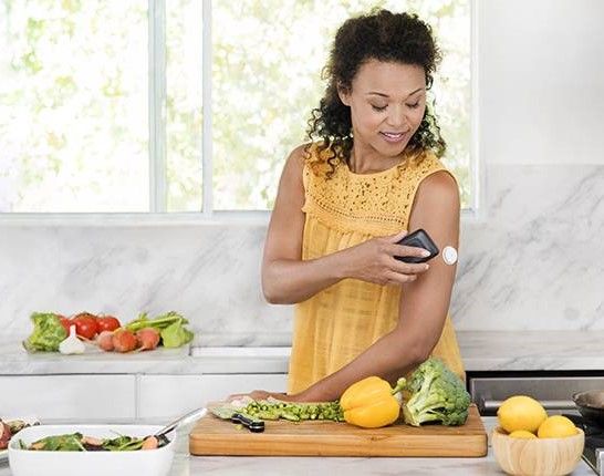 a woman using a CGM