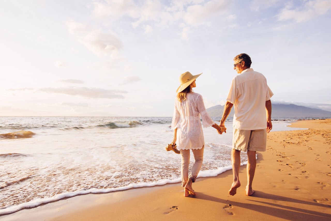 Older couple enjoying beach stroll