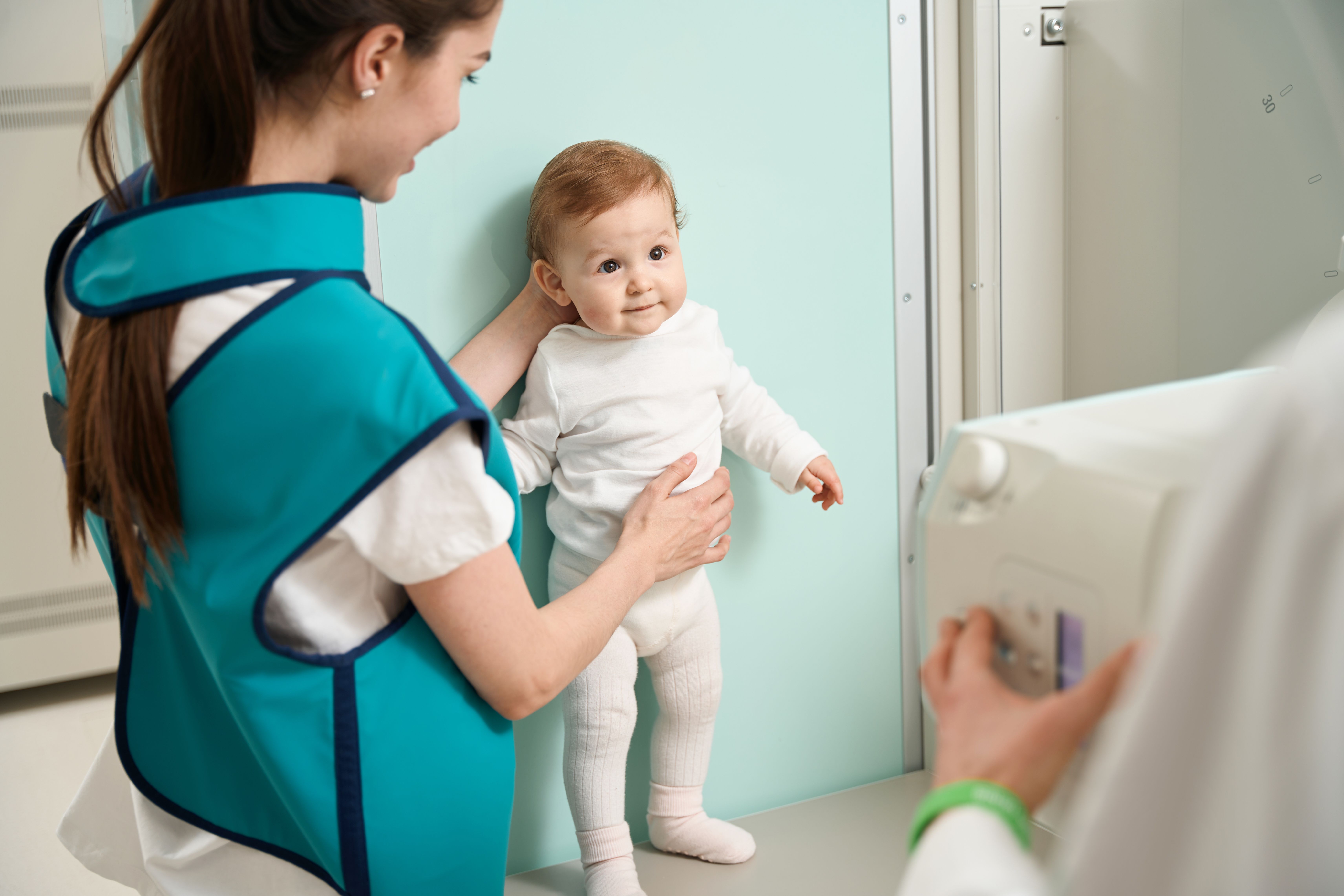 Pediatric radiologist holding child for imaging | Image credit: Svitlana – stock.adobe.com