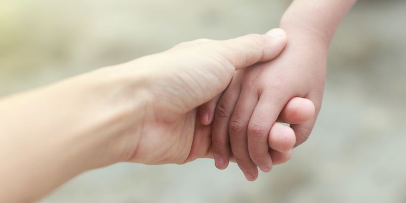 child and adult hand 