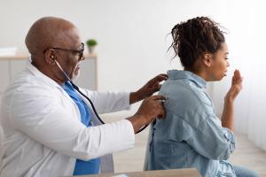 Patient coughing and doctor. | Image credit: @Prostock-studio_Adobestock.com