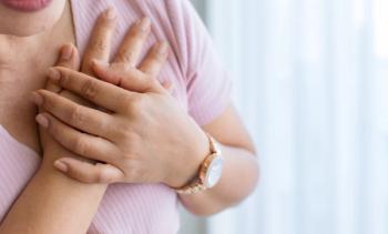 Woman holding hands over her heart | Image credit: Bangkok Click Studio - stock.adobe.com