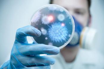 man holding petri disk containing viruses