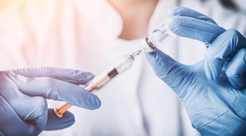 scientist filling syringe from a vial