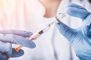 scientist filling syringe from a vial