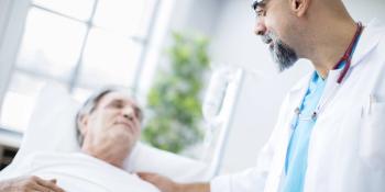 doctor comforting patient in a hospital bed