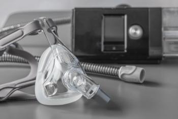 Sleep apnea CPAP mask on the grey table - sokko_natalia - stock.adobe.com
