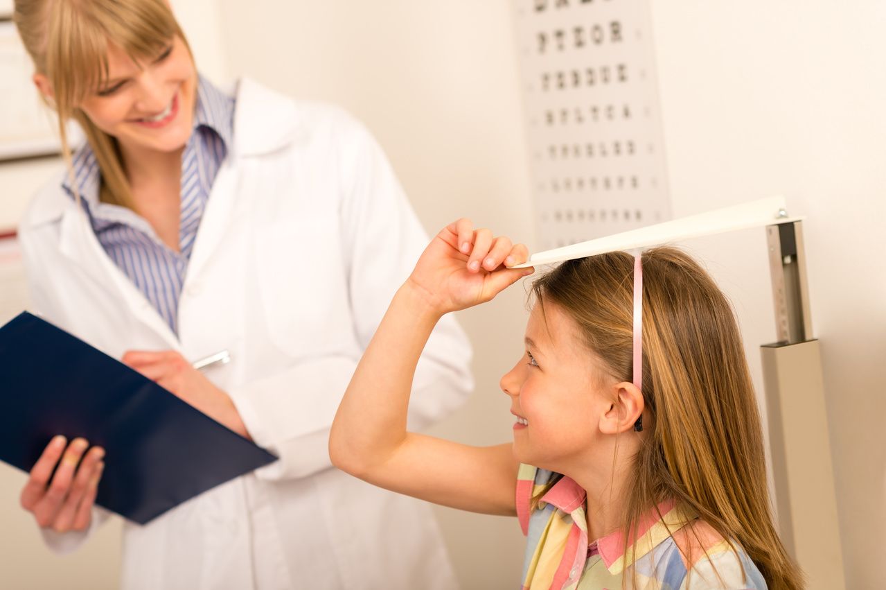 Physician measuring child's height