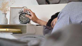 Man lying in bed and extend hand reaching to turn off alarm clock switch | Image credit: Prathankarnpap - stock.adobe.com.jpeg