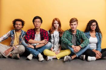 Multiracial group of serious young adults sitting | Image credit: Drobot Dean