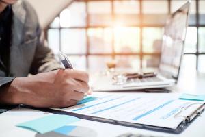 Insurance agent holding pen medical insurance, the policy and explain insurance policy to customer. life insurance concept. | Image credit sodawhiskey_AdobeStock_165774141.jpeg