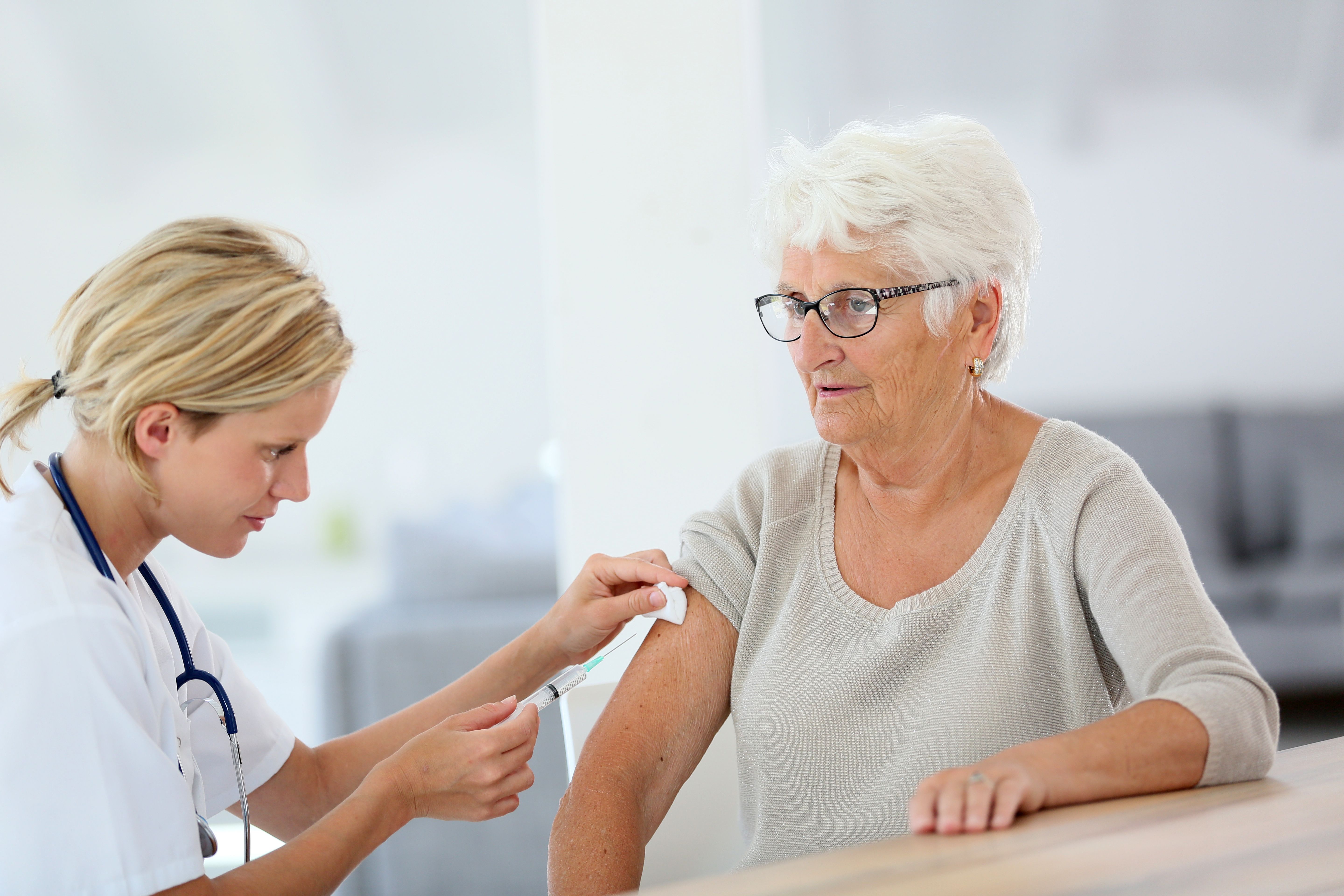 older woman receiving vaccination