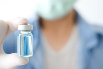 Doctor holding vial | Image credit: Photo Sesaon - stock.adobe.com