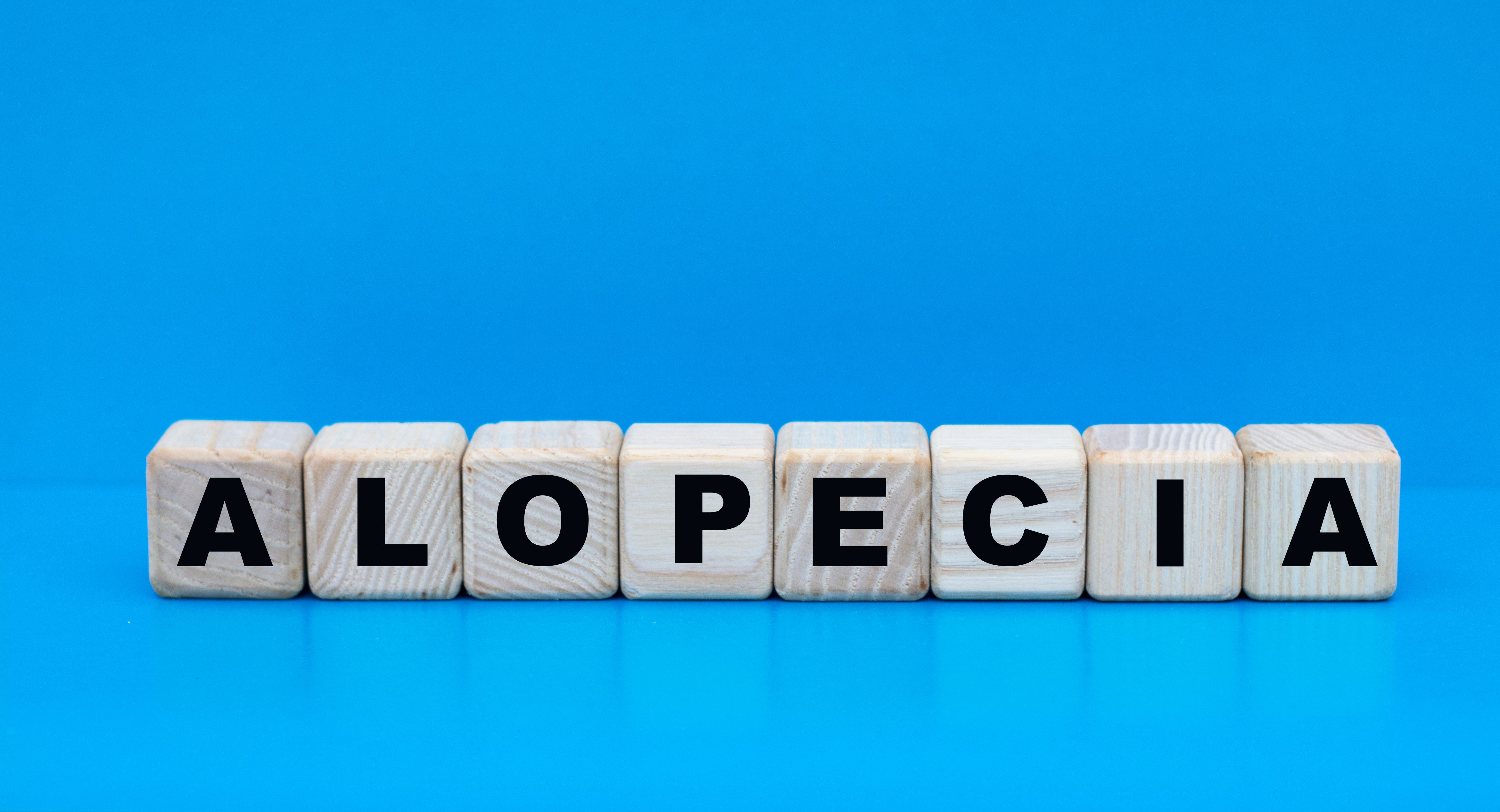 Alopecia on cubes, blue background | Image Credit:  Zhanna - stock.adobe.com