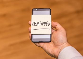 phone with reminder note on it