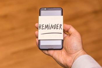 phone with reminder note on it