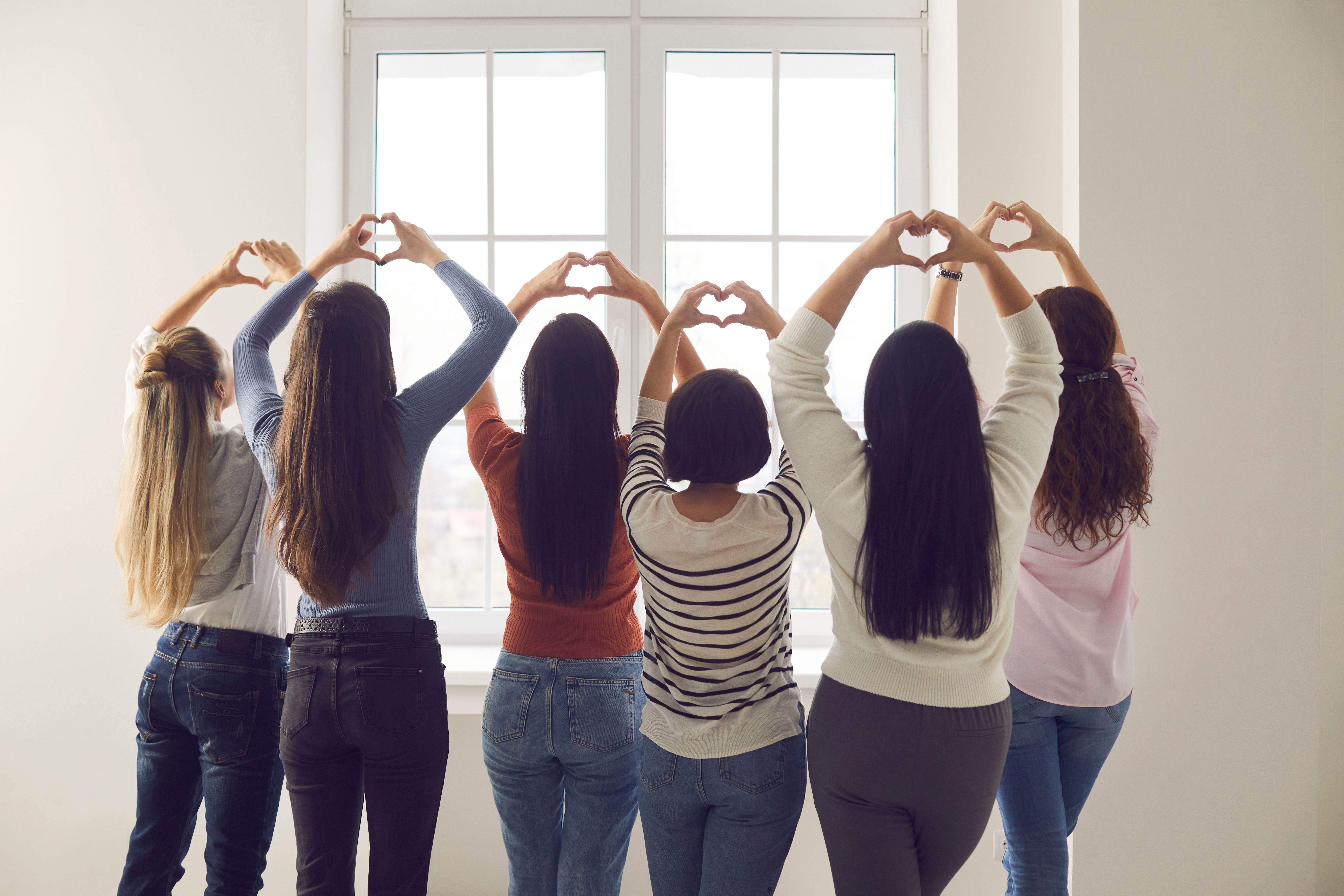 Women holding up heart hands | Image credit: Studio Romantic – stock.adobe.com