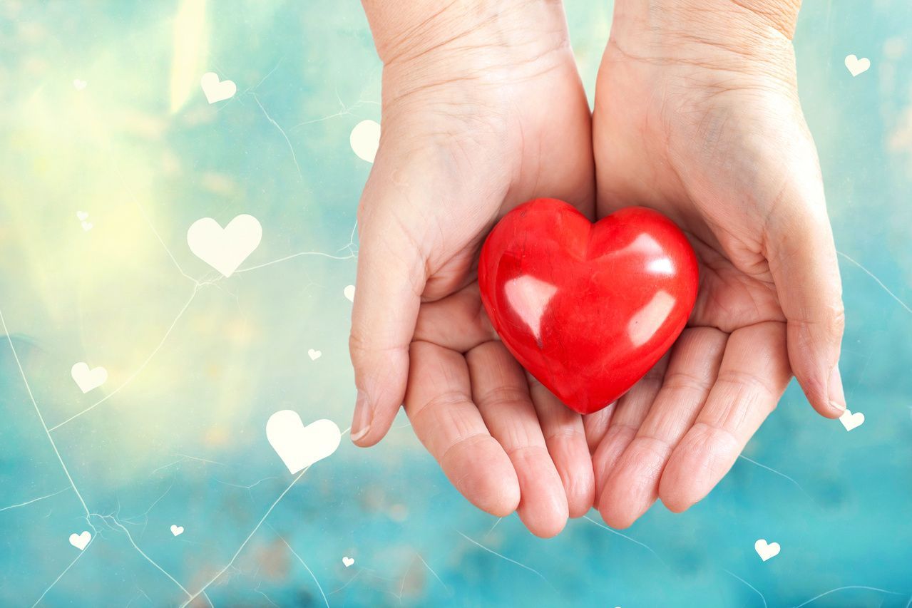 Image of hands holding a heart