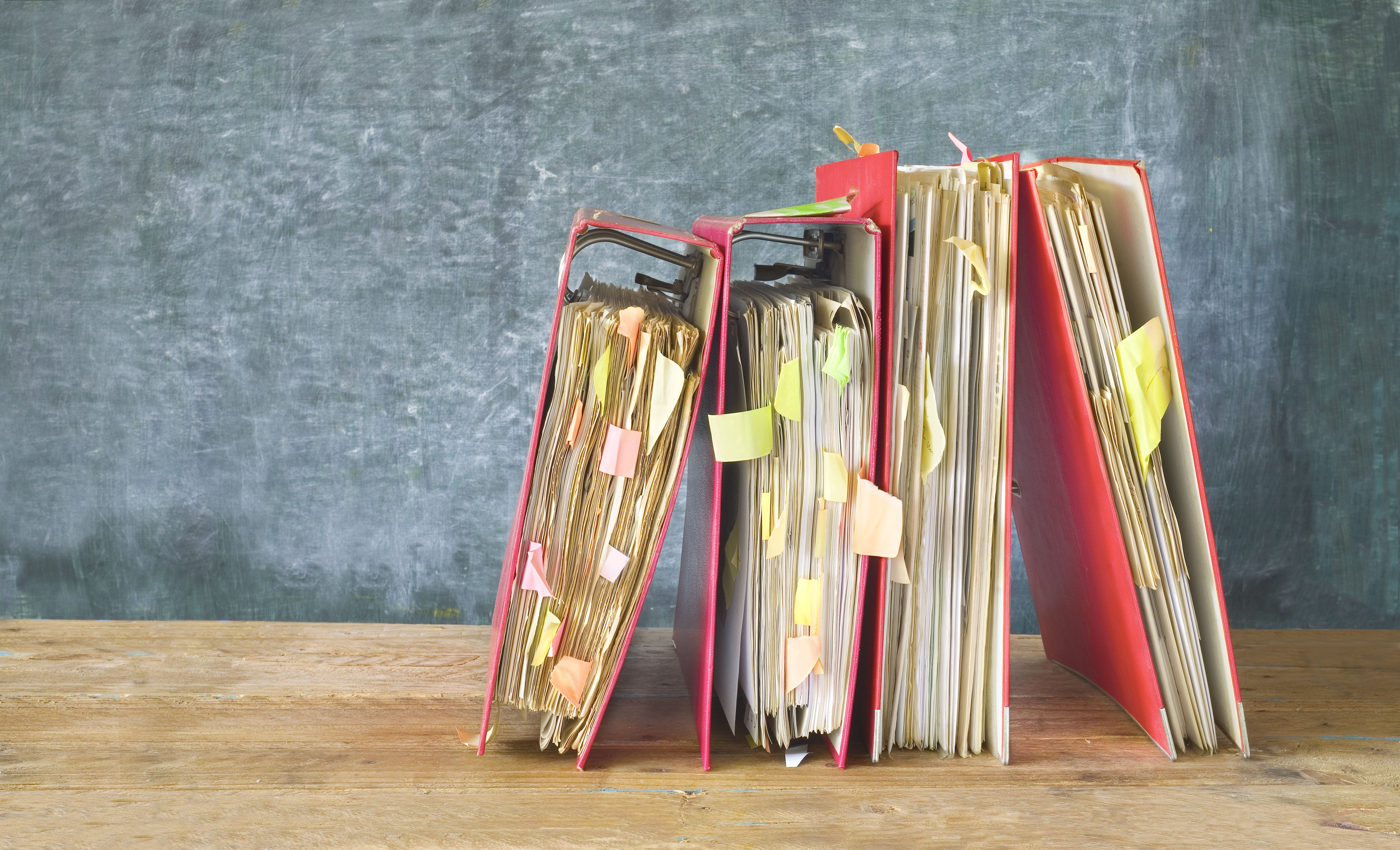 messy binders with sticky notes sticking out