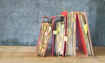 messy binders with sticky notes sticking out