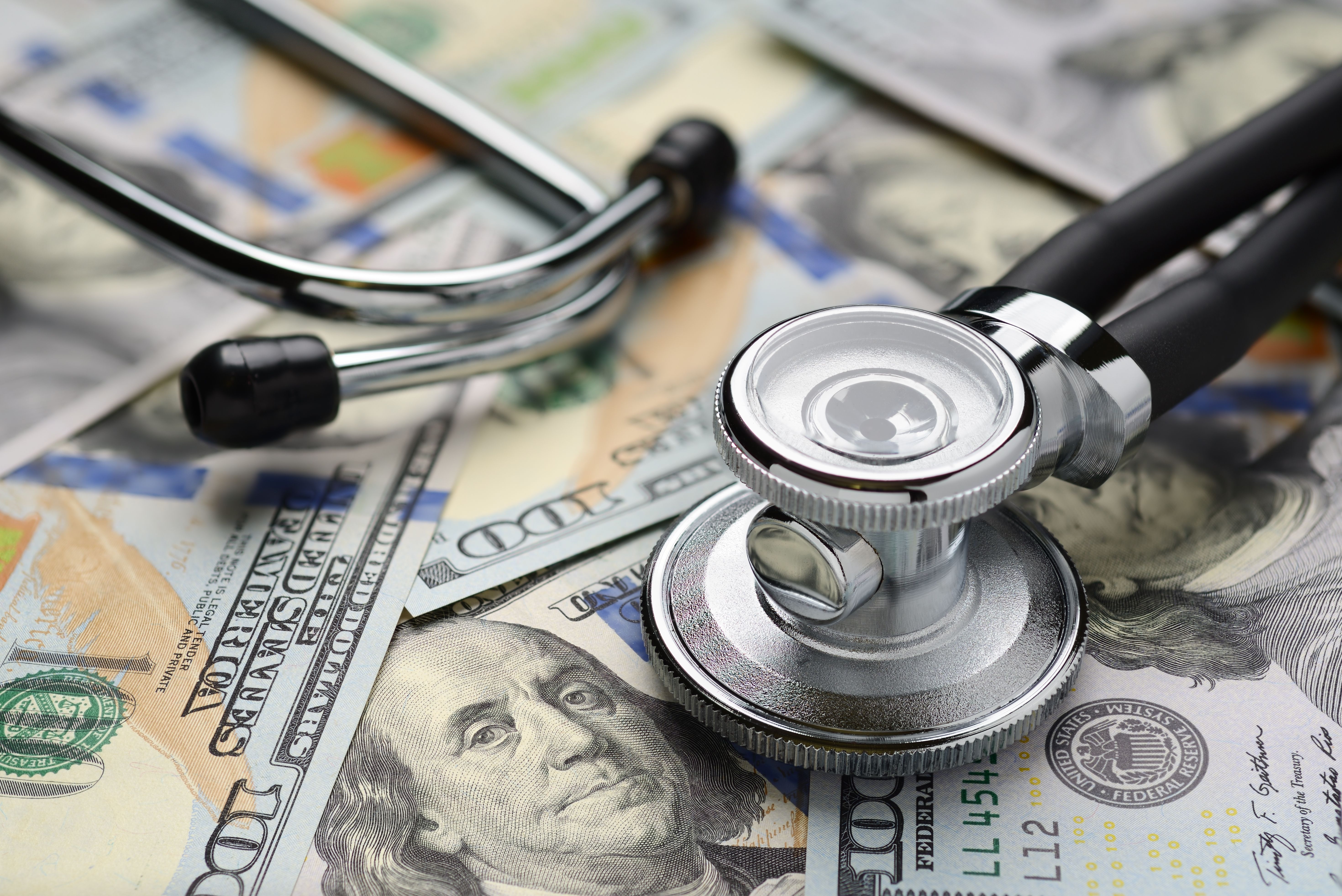 Medical stethoscope and dollar bills | Image Credit: Kuzmick – stock.adobe.com