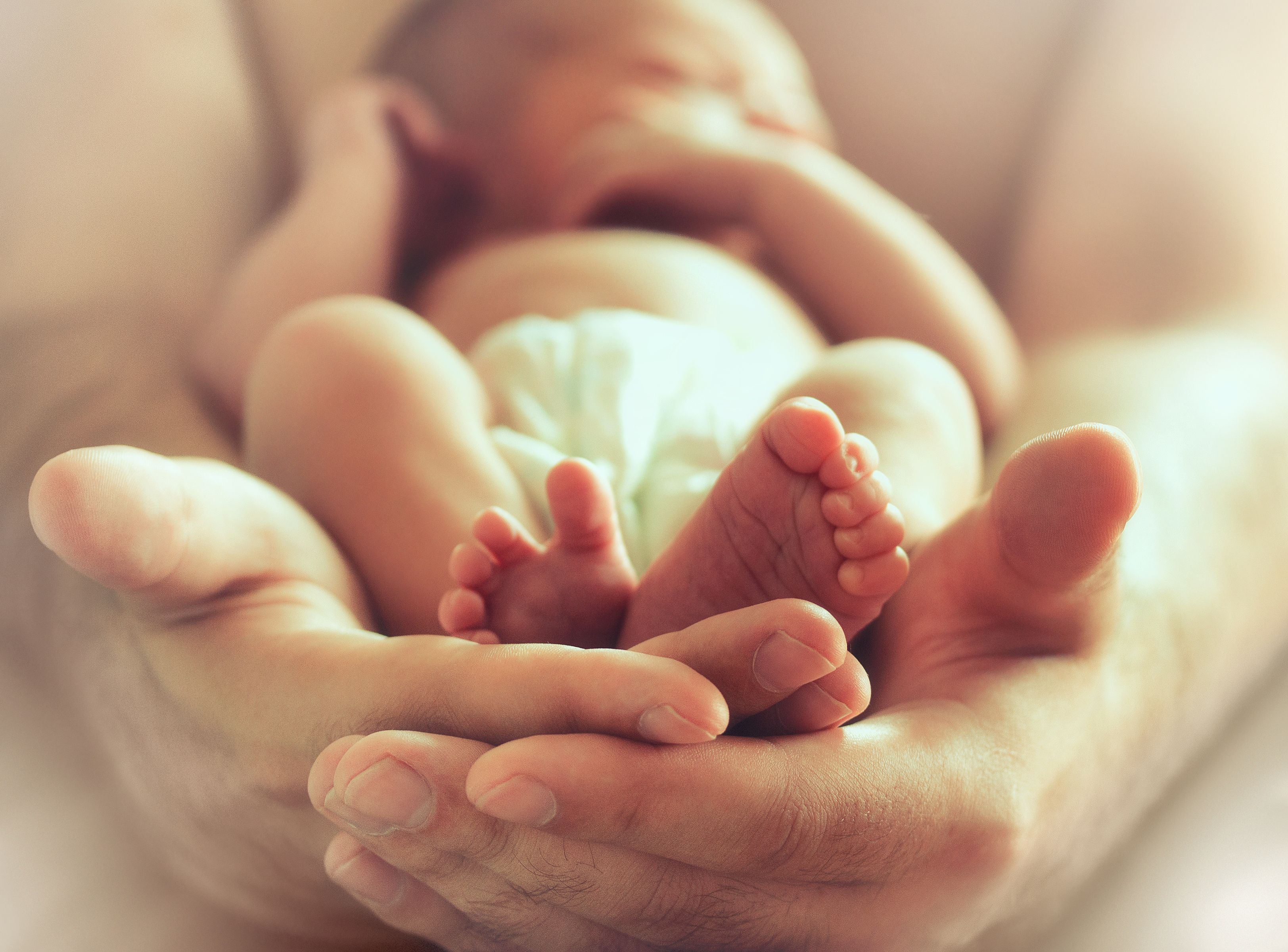 sleeping baby in father's arms | Image Credit: BazziBa - stock.adobe.com