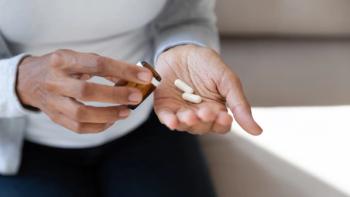 Person taking pills | Image credit: fizkes – stock.adobe.com