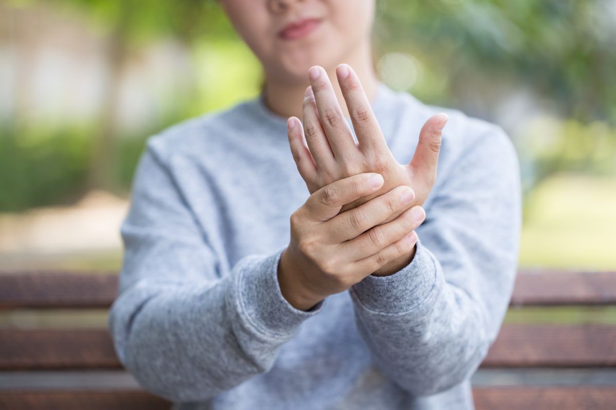 Person clenching hand.