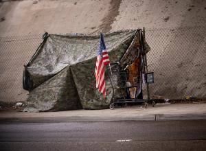 US flag in front of camouflage tent | Image credit: F Armstrong Photo – stock.adobe.com