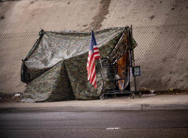 US flag in front of camouflage tent | Image credit: F Armstrong Photo – stock.adobe.com