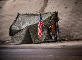 US flag in front of camouflage tent | Image credit: F Armstrong Photo – stock.adobe.com