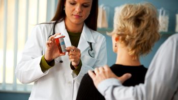 Physician showing prescription to patient and caregiver.