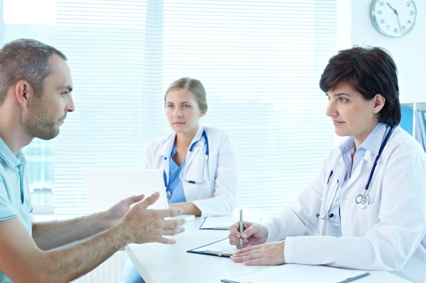 two doctors talking to patient