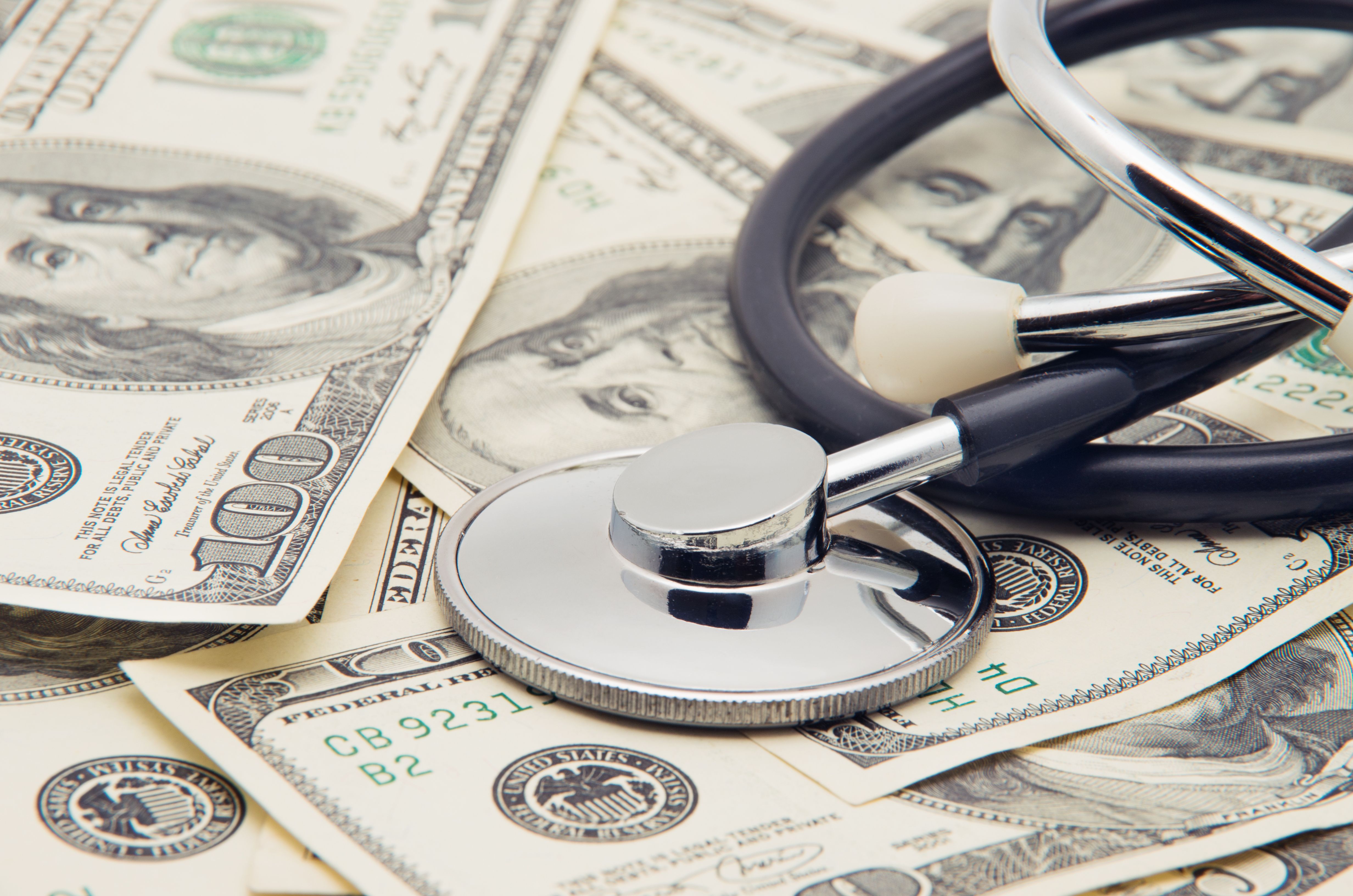 Pile of dollars and stethoscope | nata777_7 - stock.adobe.com 