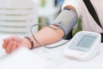 Blood pressure monitor on patient's arm | Image credit: CasanoWa Stutio – stock.adobe.com